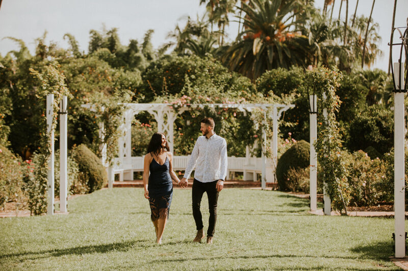 A couple walk together at the Los Angeles County Arboretum and Botanic Garden for this Los Angeles engagement photography session