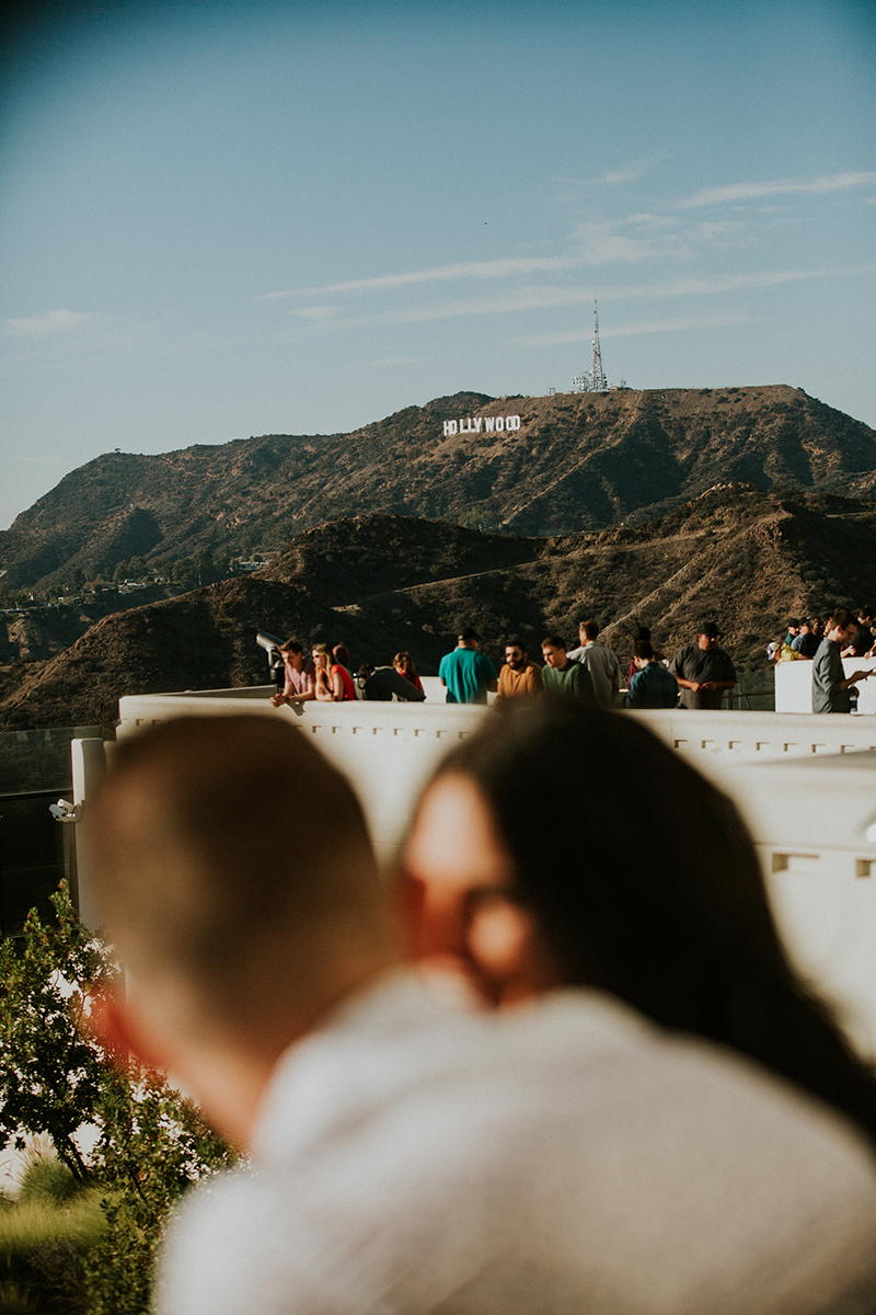 A couple talk at the Los Angeles Observatory for this Los Angeles engagement photography session