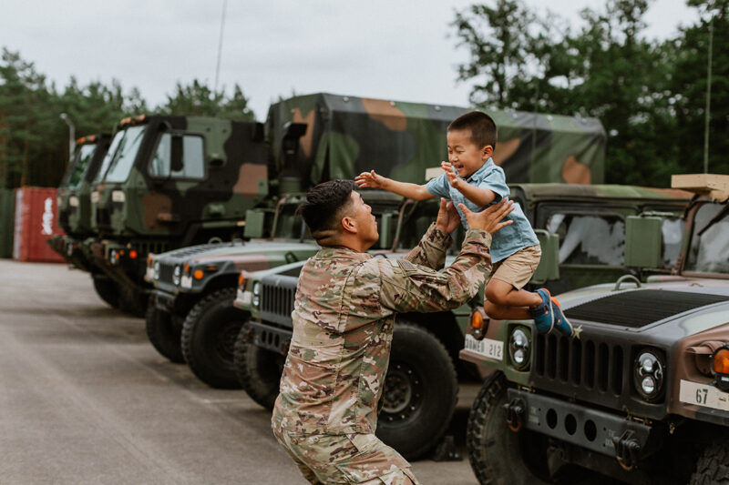 A father catches his son as they reunite at the Rhineland Ordnance Barracks for Kaiserslautern homecoming photos in Germany