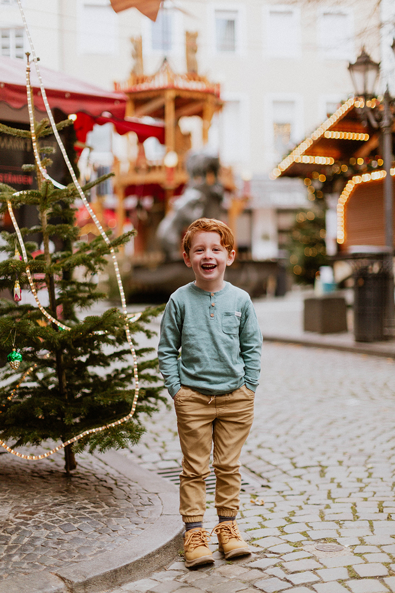 A boy poses for these Bernkastel-Kues Christmas mini sessions near Kaiserslautern, Germany