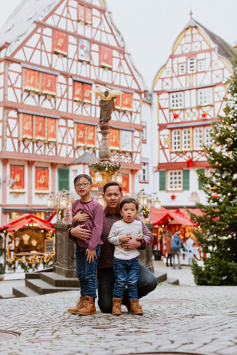 A dad poses with his sons for these Bernkastel-Kues Christmas mini sessions near Kaiserslautern, Germany