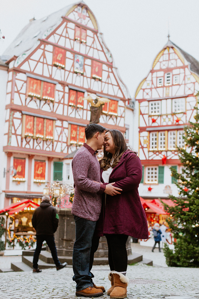 A couple poses together for these Bernkastel-Kues Christmas mini sessions near Kaiserslautern, Germany