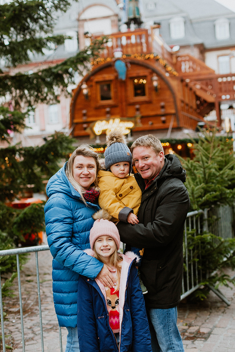 A family poses together for this Heidelberg Christmas market photography mini sessions near Kaiserslautern, Germany
