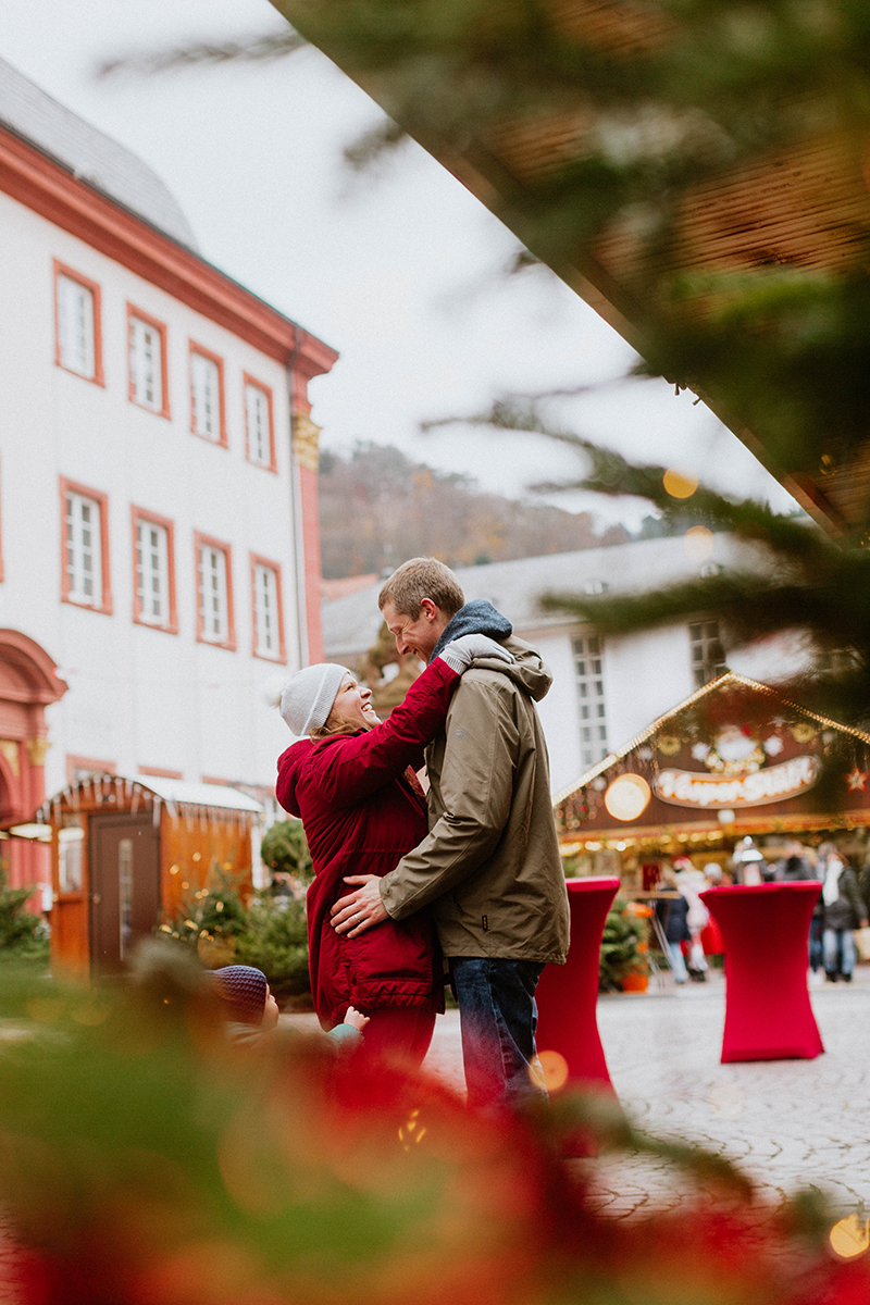 A couple poses together for this Heidelberg Christmas market photography mini sessions near Kaiserslautern, Germany
