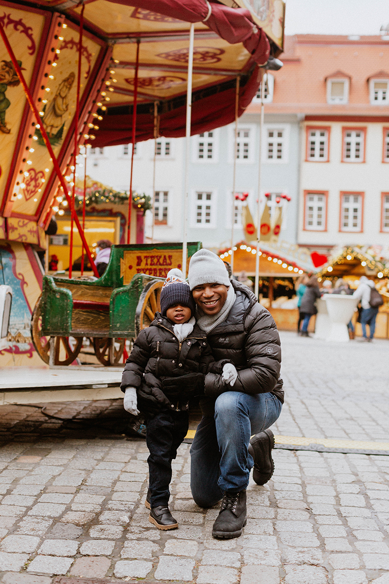 A father poses with his son for this Heidelberg Christmas market photography mini sessions near Kaiserslautern, Germany