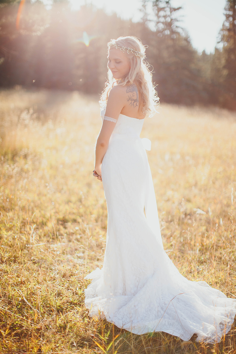 A bride stands posing at sunset wearing a white dress for this Lower Lake Ranch wedding photography session