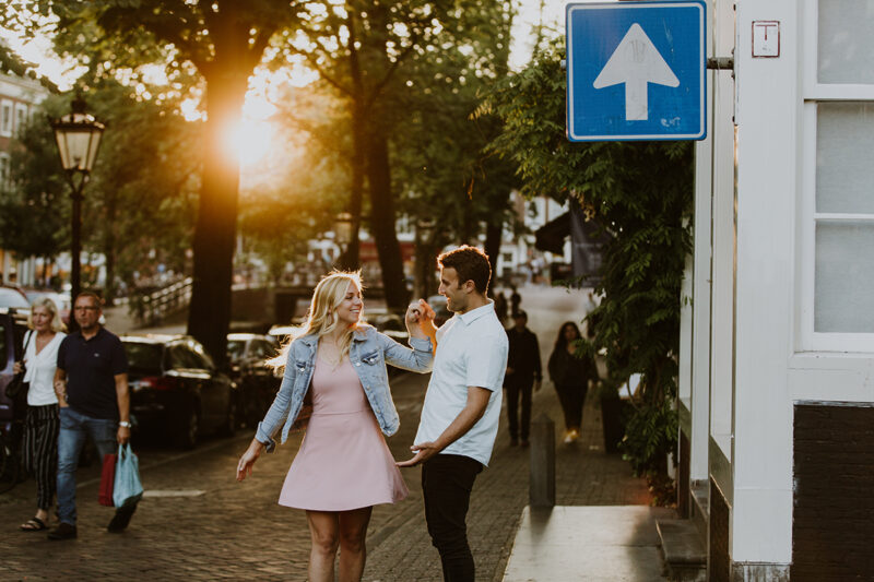A couple dance next to a canal at sunset for this Amsterdam couples photography session