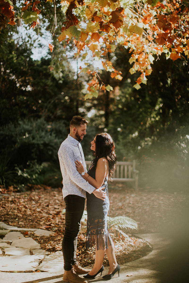 A couple hold each other at the Los Angeles County Arboretum and Botanic Garden for this Los Angeles engagement photography session