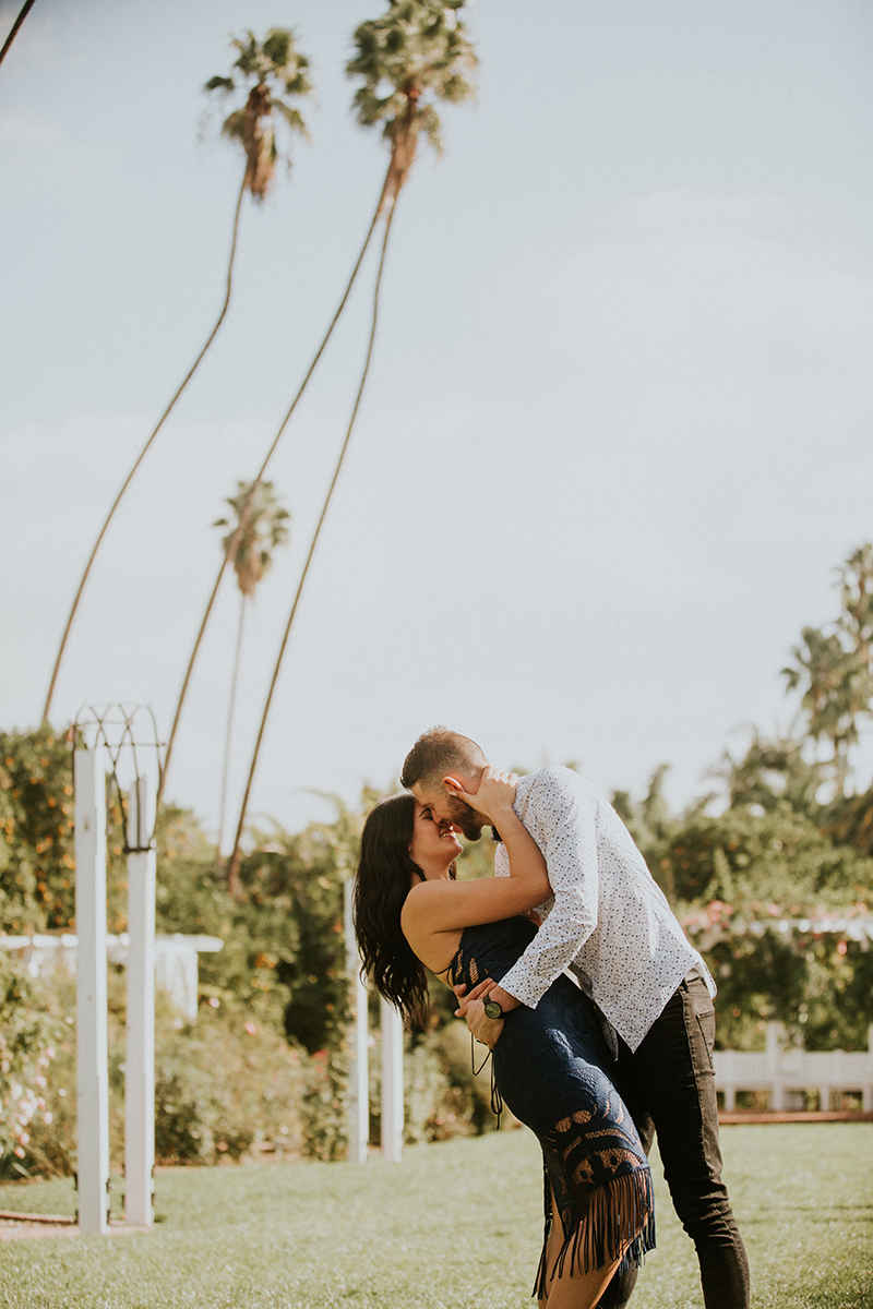 A couple hold each other and dip at the Los Angeles County Arboretum and Botanic Garden for this Los Angeles engagement photography session