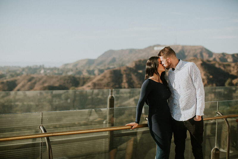 A couple hold each other and kiss at the Los Angeles Observatory for this Los Angeles engagement photography session