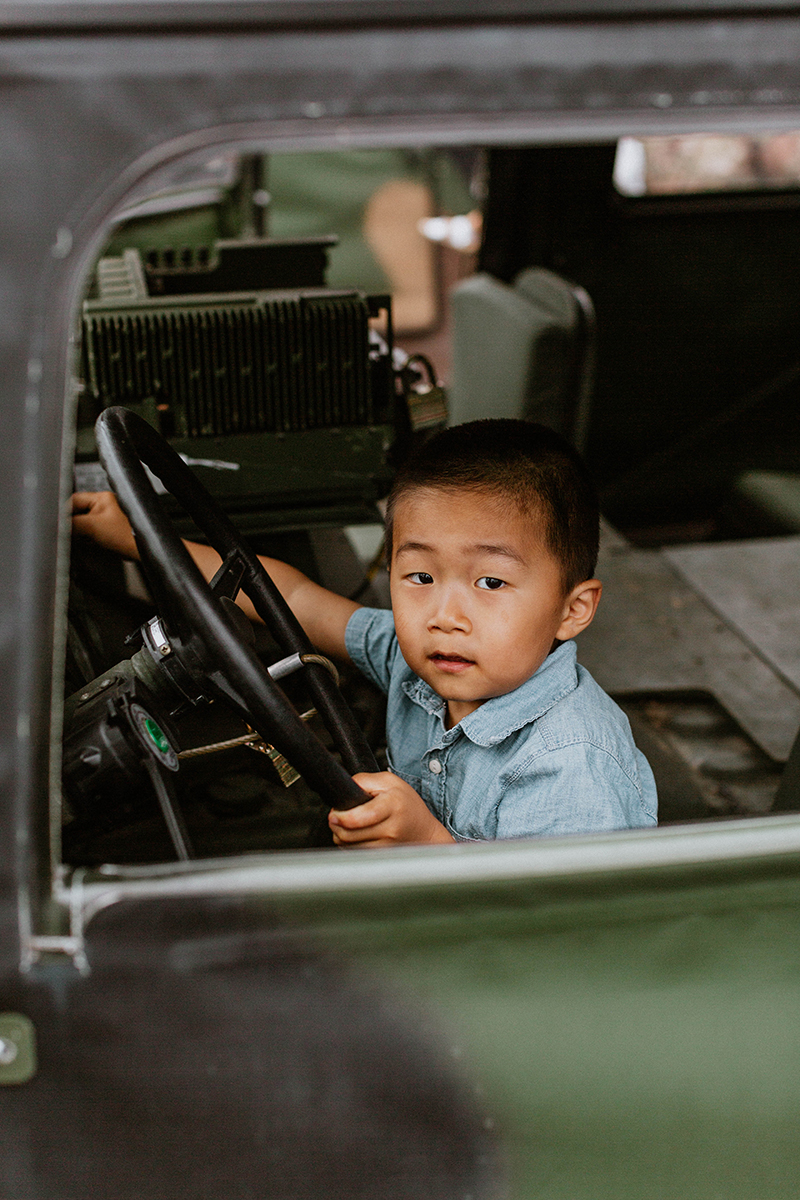 A young boy pretends to drive a humvee as they reunite at the Rhineland Ordnance Barracks for Kaiserslautern homecoming photos in Germany