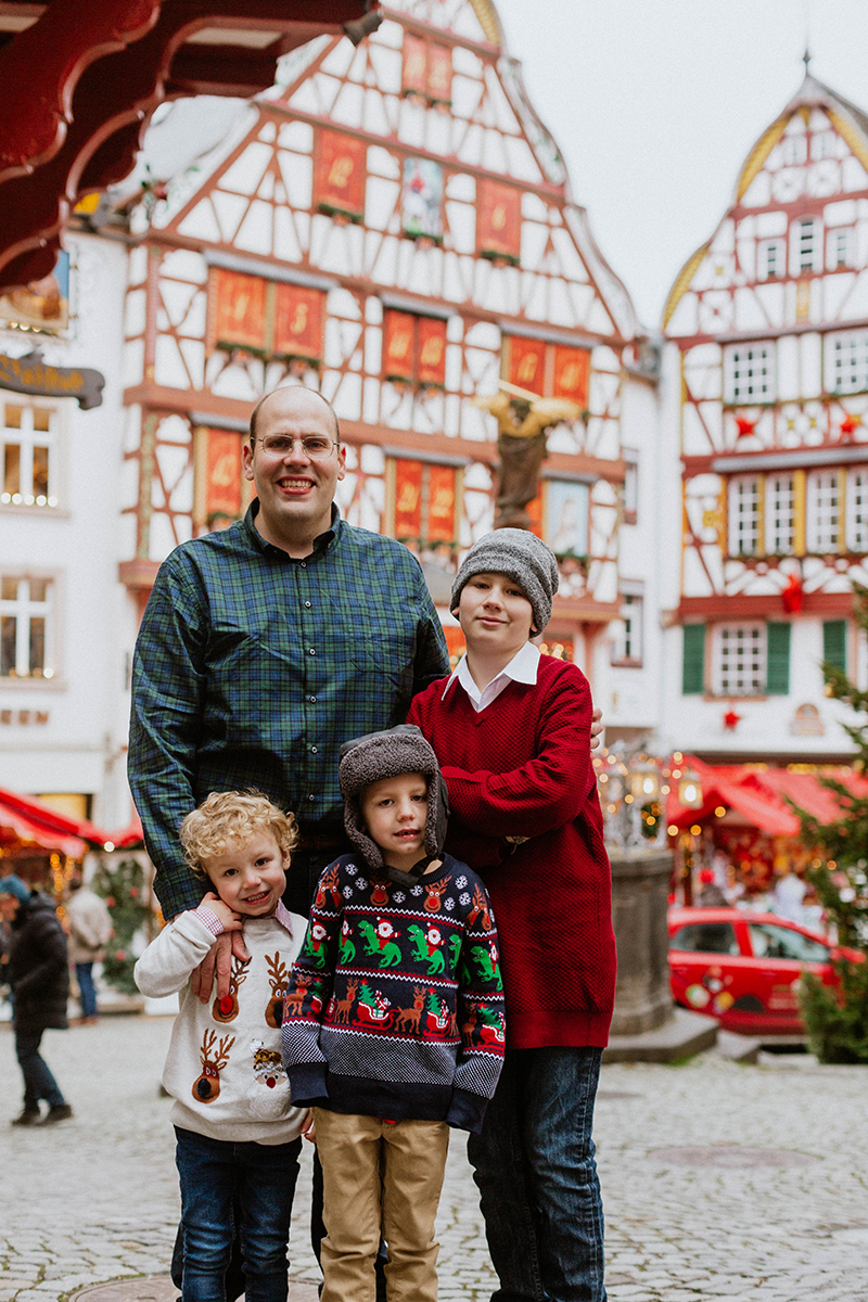 A dad poses with his sons for these Bernkastel-Kues Christmas mini sessions near Kaiserslautern, Germany
