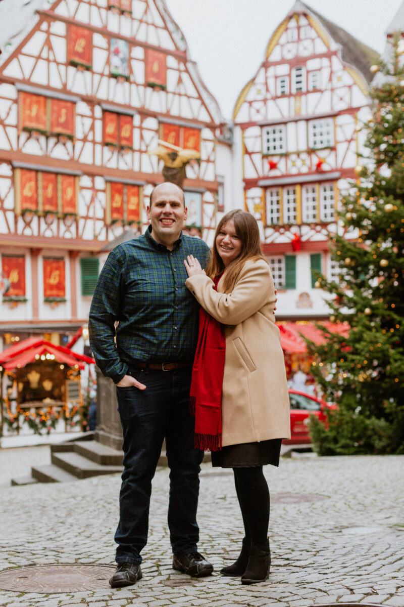 A couple poses together for these Bernkastel-Kues Christmas mini sessions near Kaiserslautern, Germany