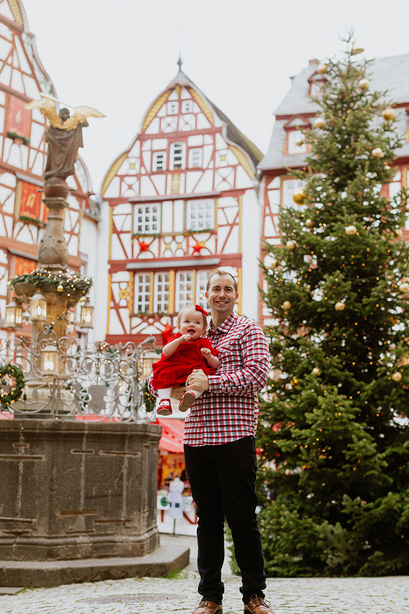 A father poses with his daughter for these Bernkastel-Kues Christmas mini sessions near Kaiserslautern, Germany