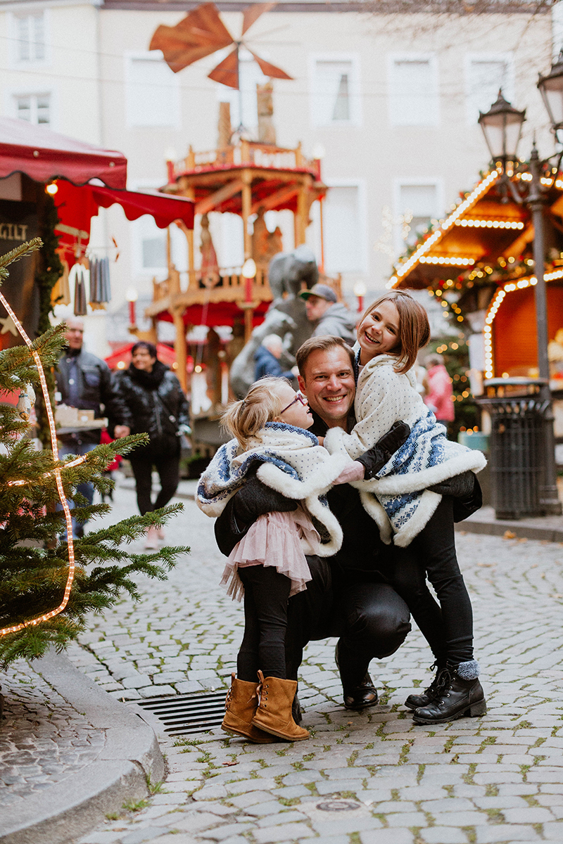 A father poses with his daughters for these Bernkastel-Kues Christmas mini sessions near Kaiserslautern, Germany