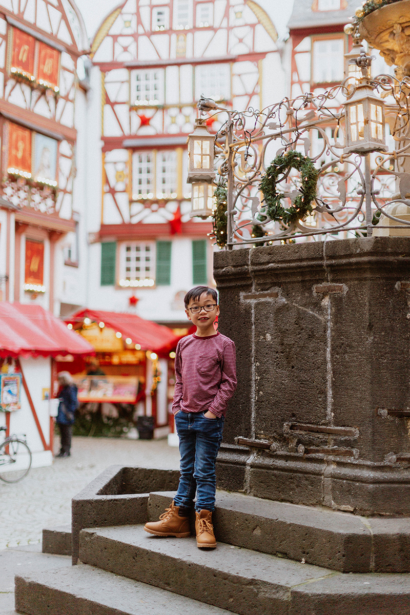A young boy poses for these Bernkastel-Kues Christmas mini sessions near Kaiserslautern, Germany