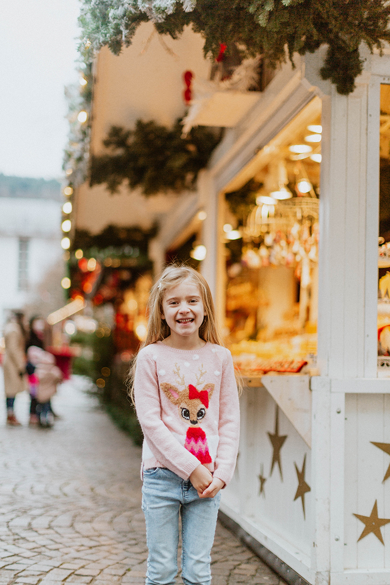 A young girl poses for this Heidelberg Christmas market photography mini sessions near Kaiserslautern, Germany