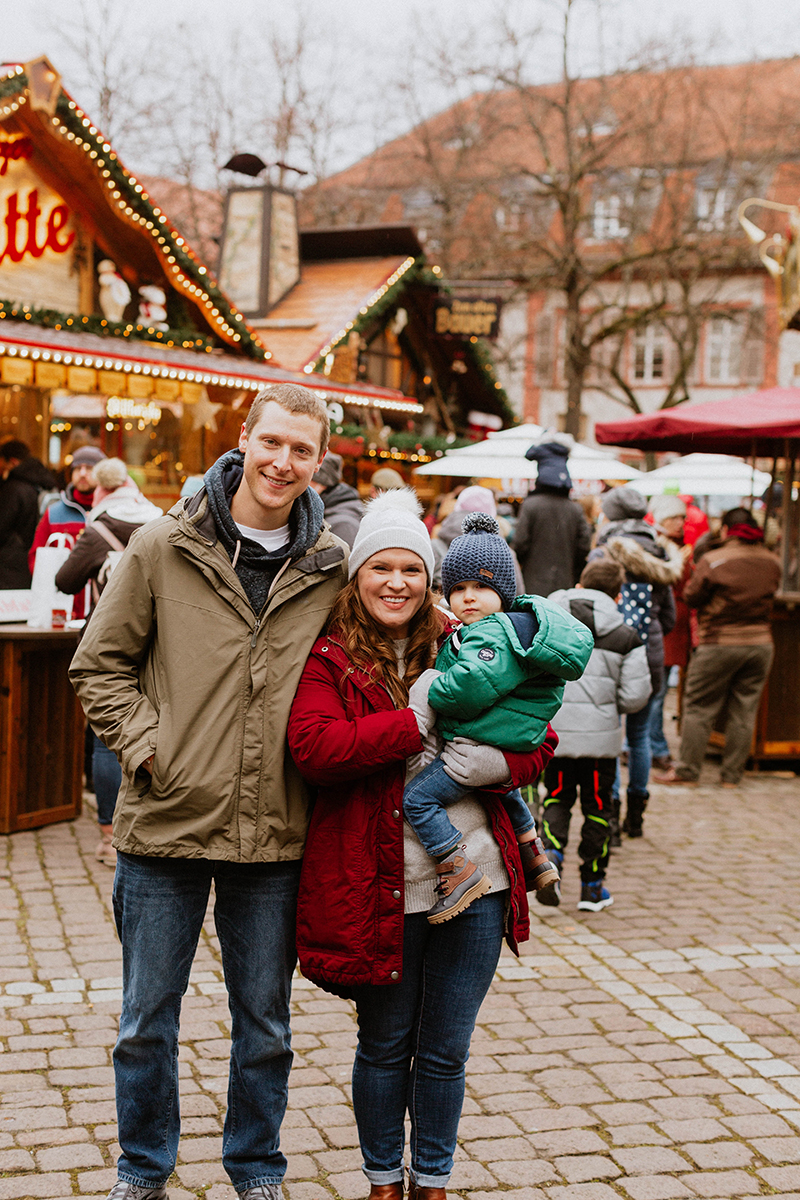 A family poses together for this Heidelberg Christmas market photography mini sessions near Kaiserslautern, Germany